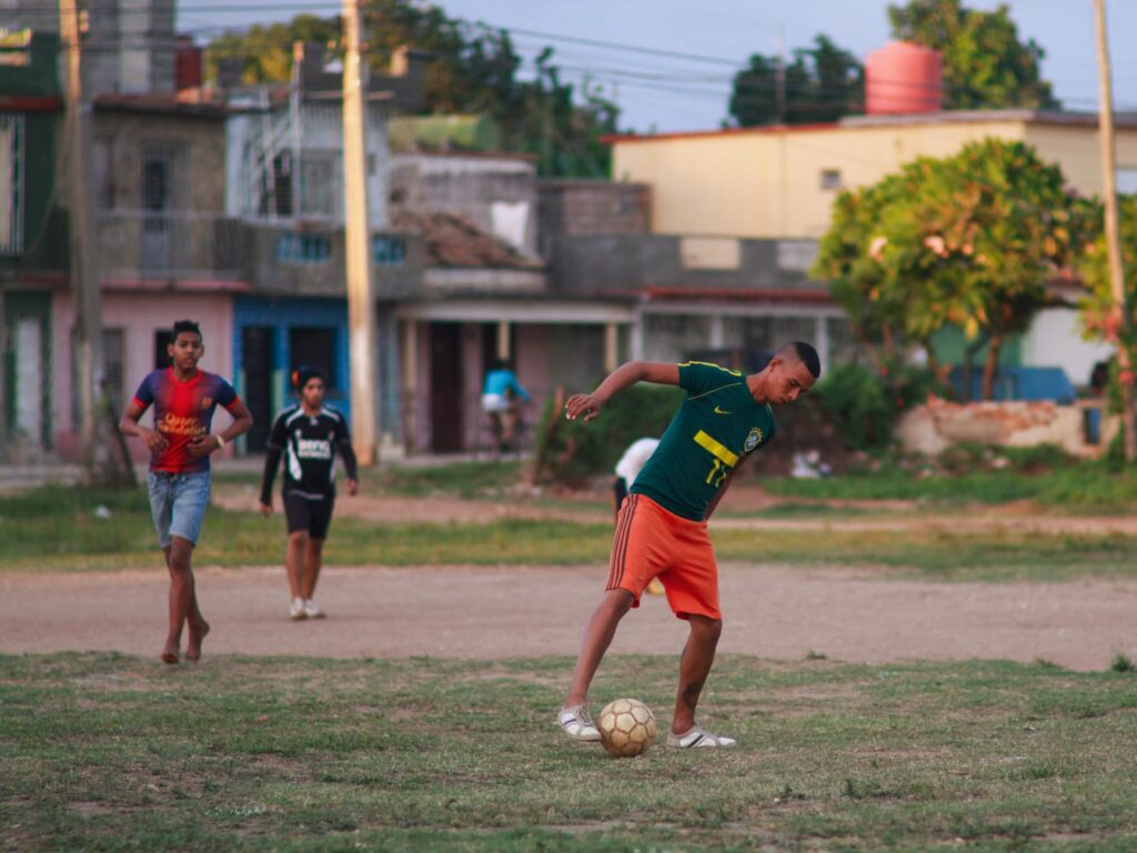 men playing soccer at the street